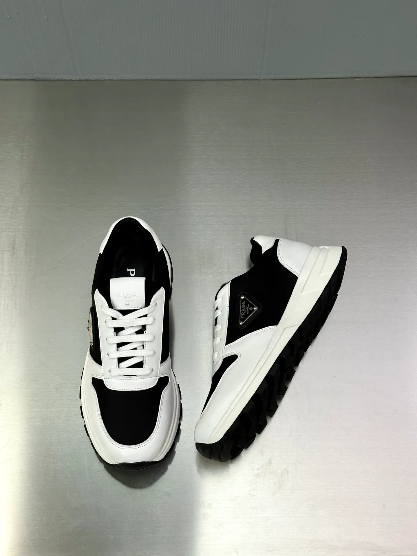 💰740 Prada/Prada men's new mesh stitching sneakers. This sneaker presents a modern version, reinterpreting the brand's archive style with clean lines and smooth details. The shoes are made of calf leather and technical fabric, with a triangular metal logo on the outside, bright TPU decoration on the heel, and a longer and padded inner heel design for a more comfortable fit. The tongue is decorated with a silk-screen logo, and is paired with a hollow rubber sole on the heel. The full cowhide lining comes standard with logo cowhide foot pads, making the upper foot taller, more comfortable, and versatile! Comes with full original packaging! Size: 39-40-41-42-43-44 standard leather shoe size (45 can be customized and does not support returns)